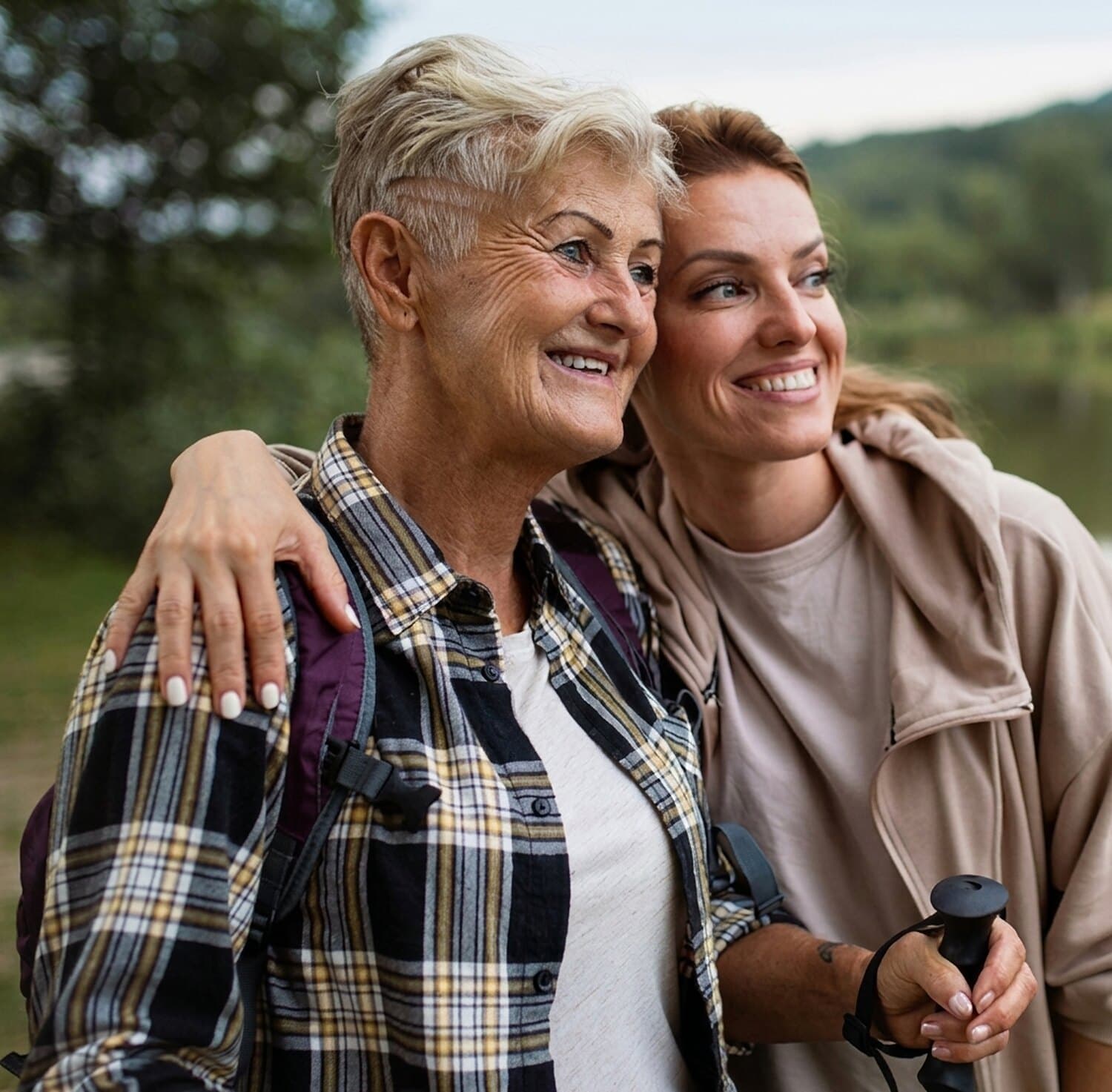 Two women smiling outdoors, representing care from a trusted provider network.